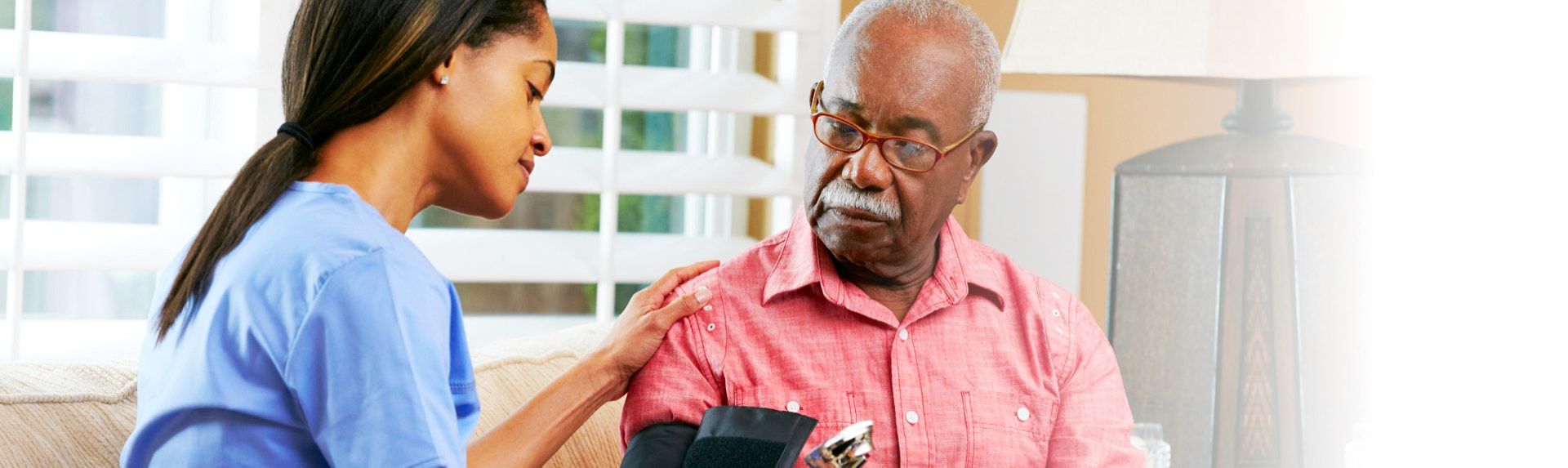 caregiver taking blood pressure