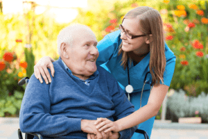 young nurse with elderly patient at the nursing home