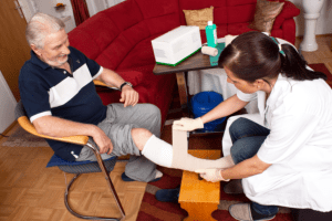 nurse treating the wound of her patient